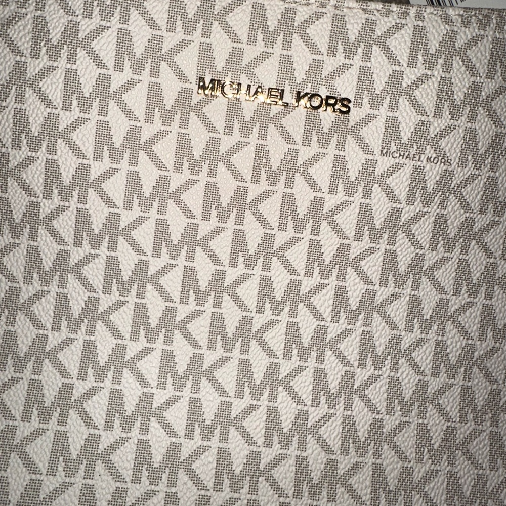 Michael Kors Cream and tan Messenger Jet Set Purse.
